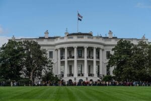 A picturesque view of the White House with the American flag in daylight.