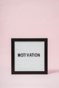 A letter board with 'Motivation' text on a soft pink background, perfect for inspirational themes.