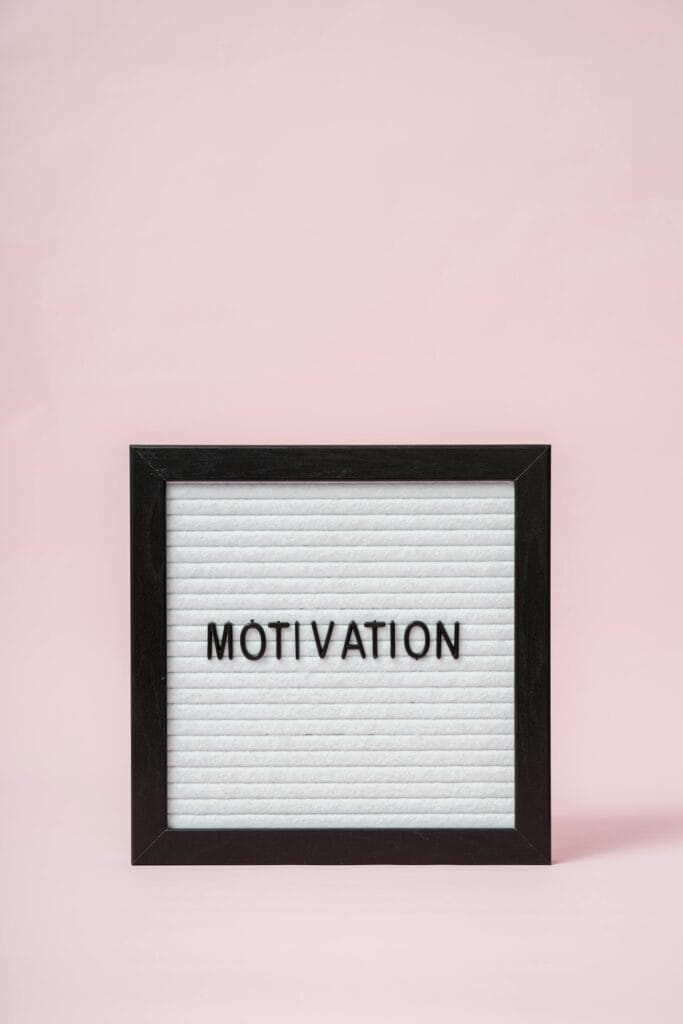 A letter board with 'Motivation' text on a soft pink background, perfect for inspirational themes.