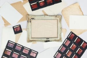 A collection of vintage film slides and an ornate picture frame arranged on old paper.