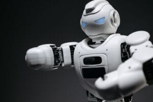 Detailed close-up of a high-tech white robot in a studio setting with a gray background.